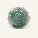 Close-up of the Jadeite Rose Ring in rose gold, resting on a warm linen background
