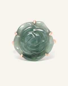 Close-up of the Jadeite Rose Ring in rose gold, resting on a warm linen background