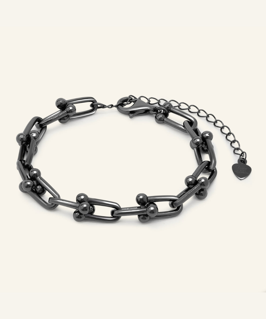Lock Link Bracelet | Elate in black gold, resting on a warm linen background
