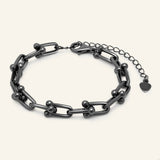 Lock Link Bracelet | Elate in black gold, resting on a warm linen background