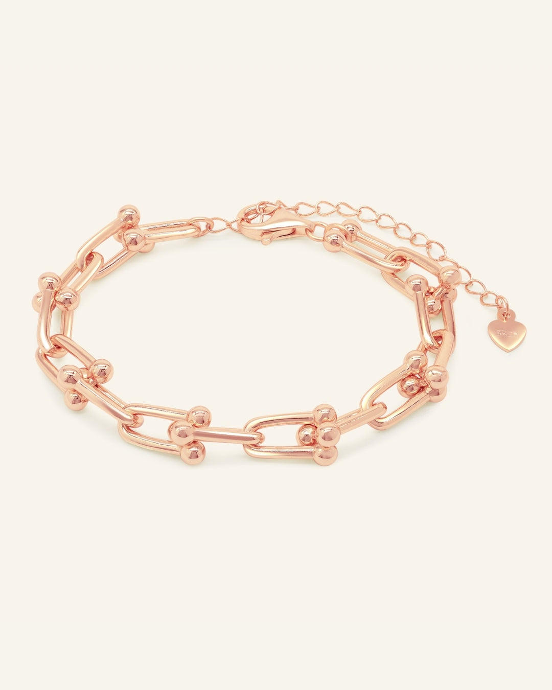 Lock Link Bracelet | Elate in rose gold, resting on a warm linen background