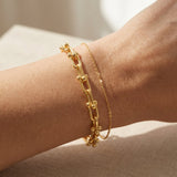 Lock Link Bracelet | Elate in yellow gold, resting on a warm linen background