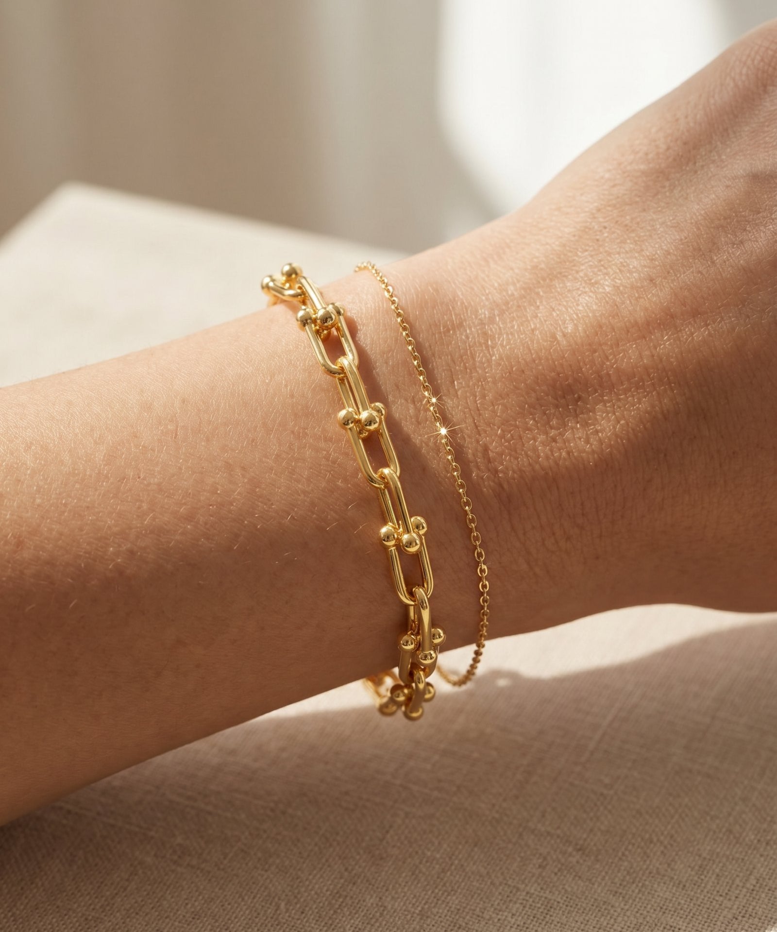 Lock Link Bracelet | Elate in yellow gold, resting on a warm linen background
