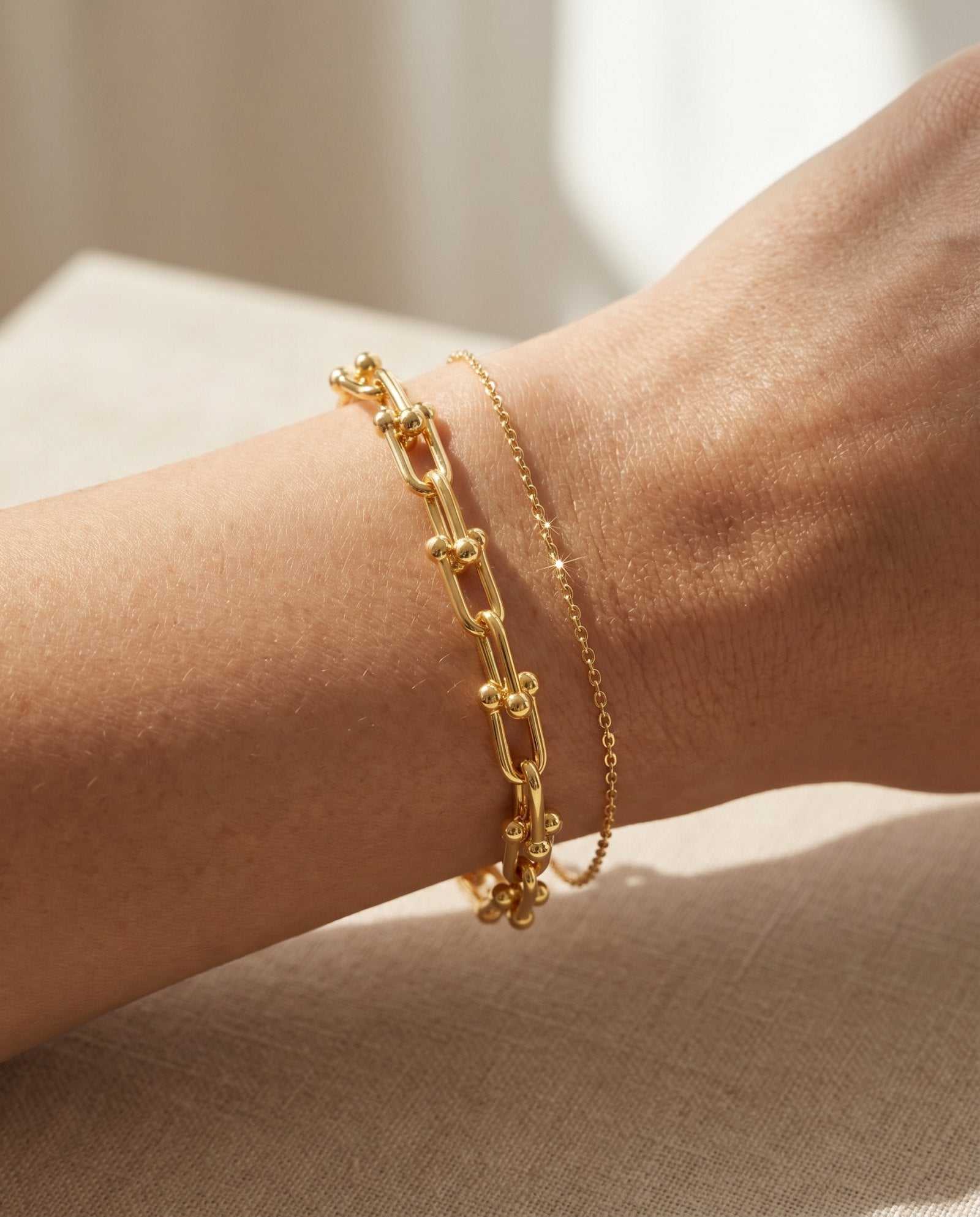 Lock Link Bracelet | Elate in yellow gold, resting on a warm linen background