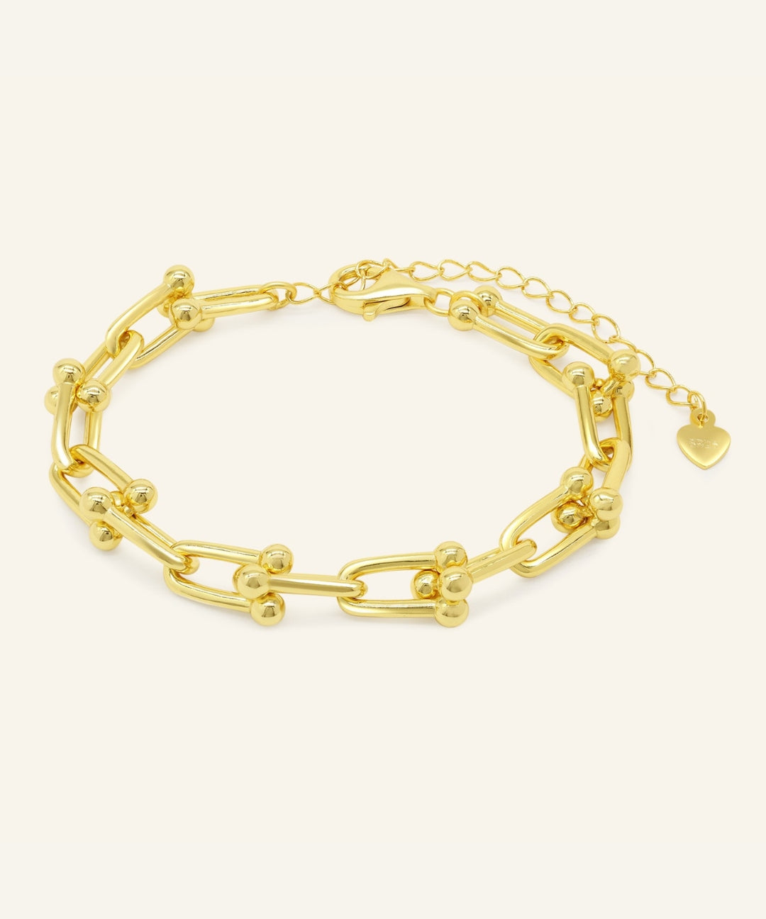 Lock Link Bracelet | Elate in yellow gold, resting on a warm linen background