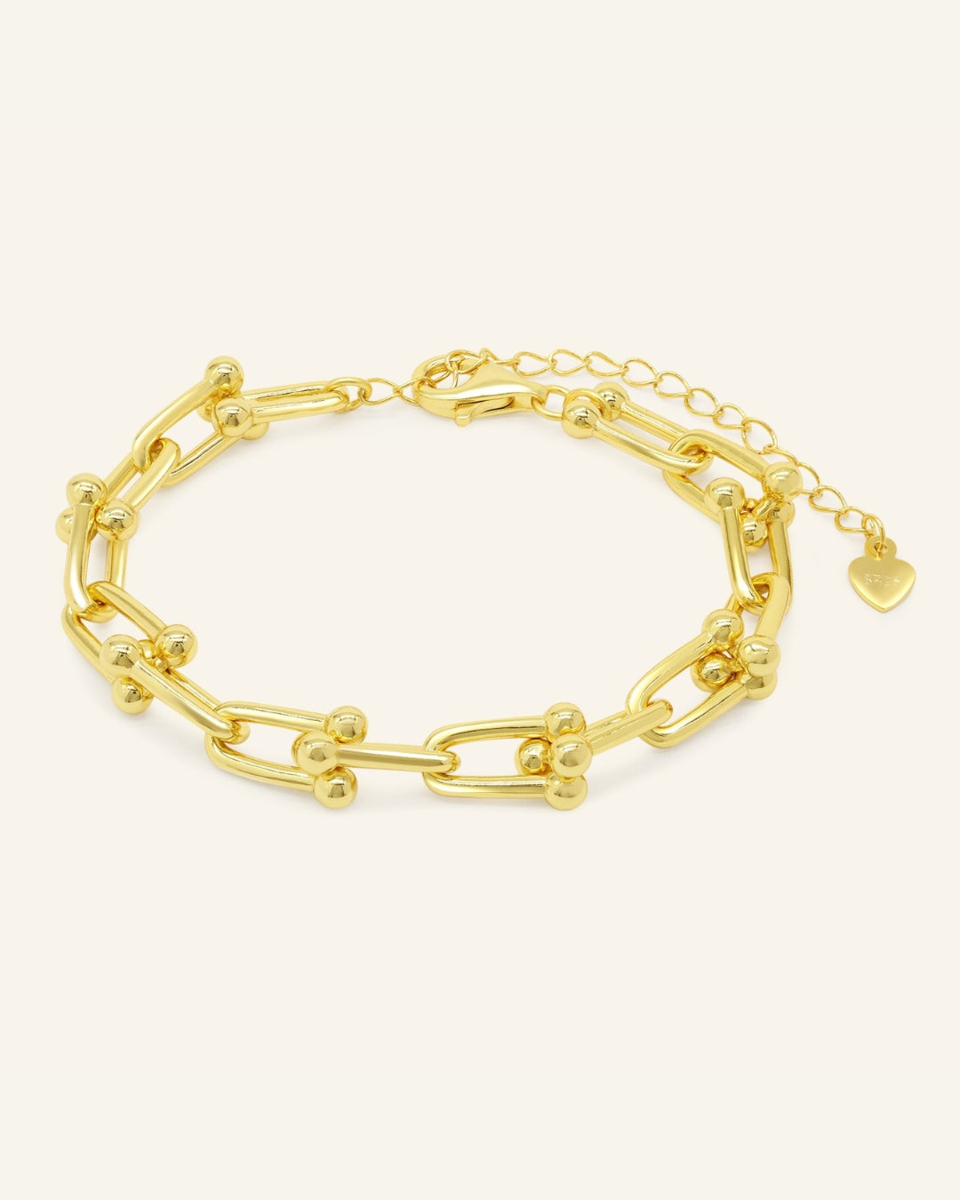 Lock Link Bracelet | Elate in yellow gold, resting on a warm linen background