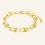 Lock Link Bracelet | Elate in yellow gold, resting on a warm linen background