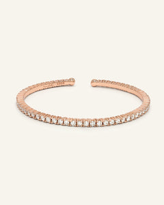 Lumina Moissanite Cuff | Elate in rose gold, resting on a warm linen background