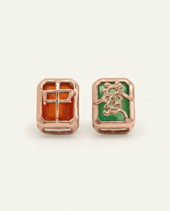 Close-up of the Mahjong Studs | Red & Green Agate in rose gold, resting on a warm linen background
