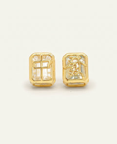 Close-up of the Mahjong Tile Studs in yellow gold with white topaz, resting on a warm linen background