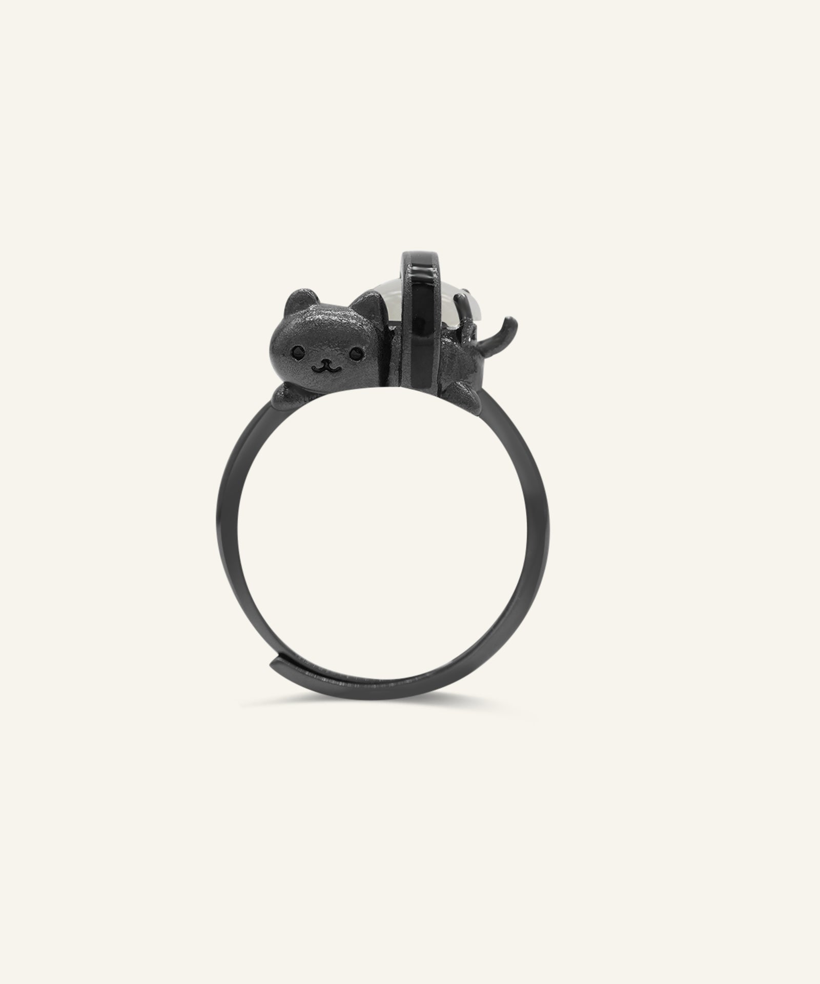 Maki Meow Sushi Ring | White Jade in black gold, resting on a warm linen background