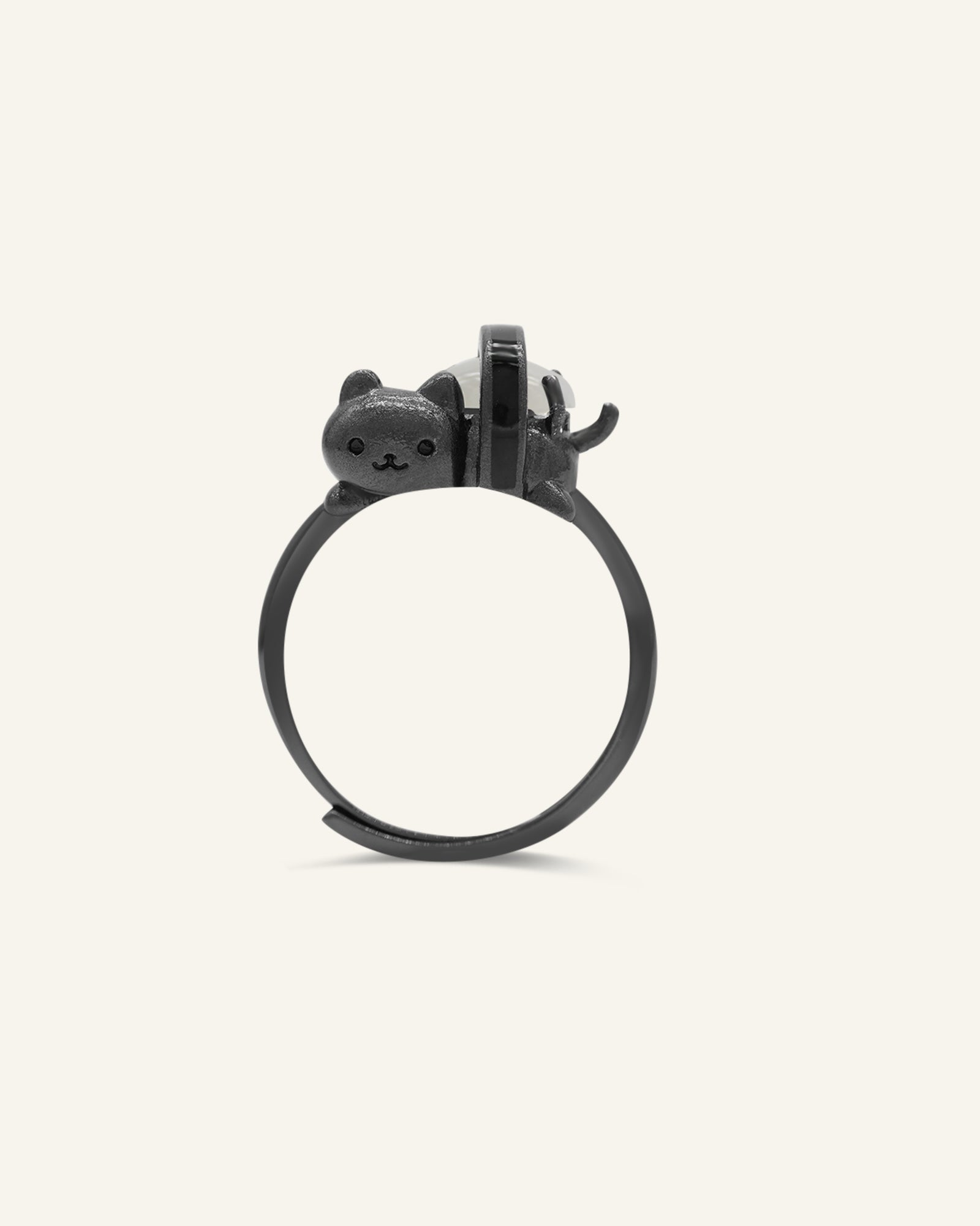 Maki Meow Sushi Ring | White Jade in black gold, resting on a warm linen background