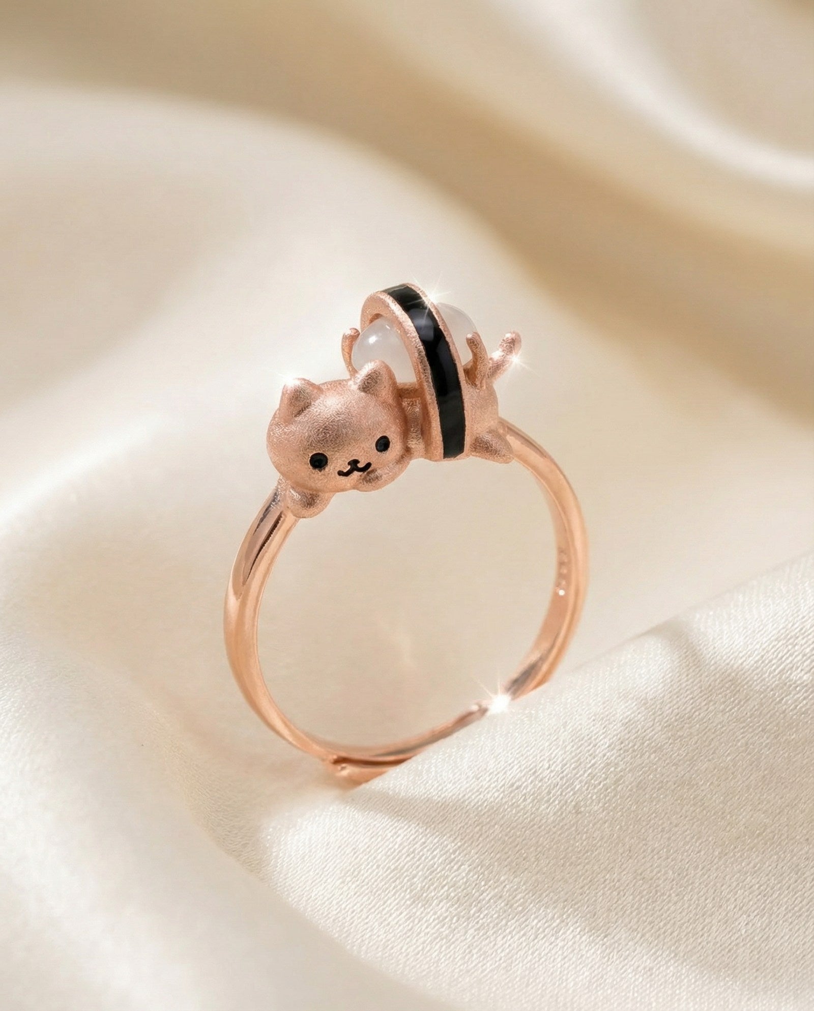 Maki Meow Sushi Ring | White Jade in rose gold, laid flat on a tabletop