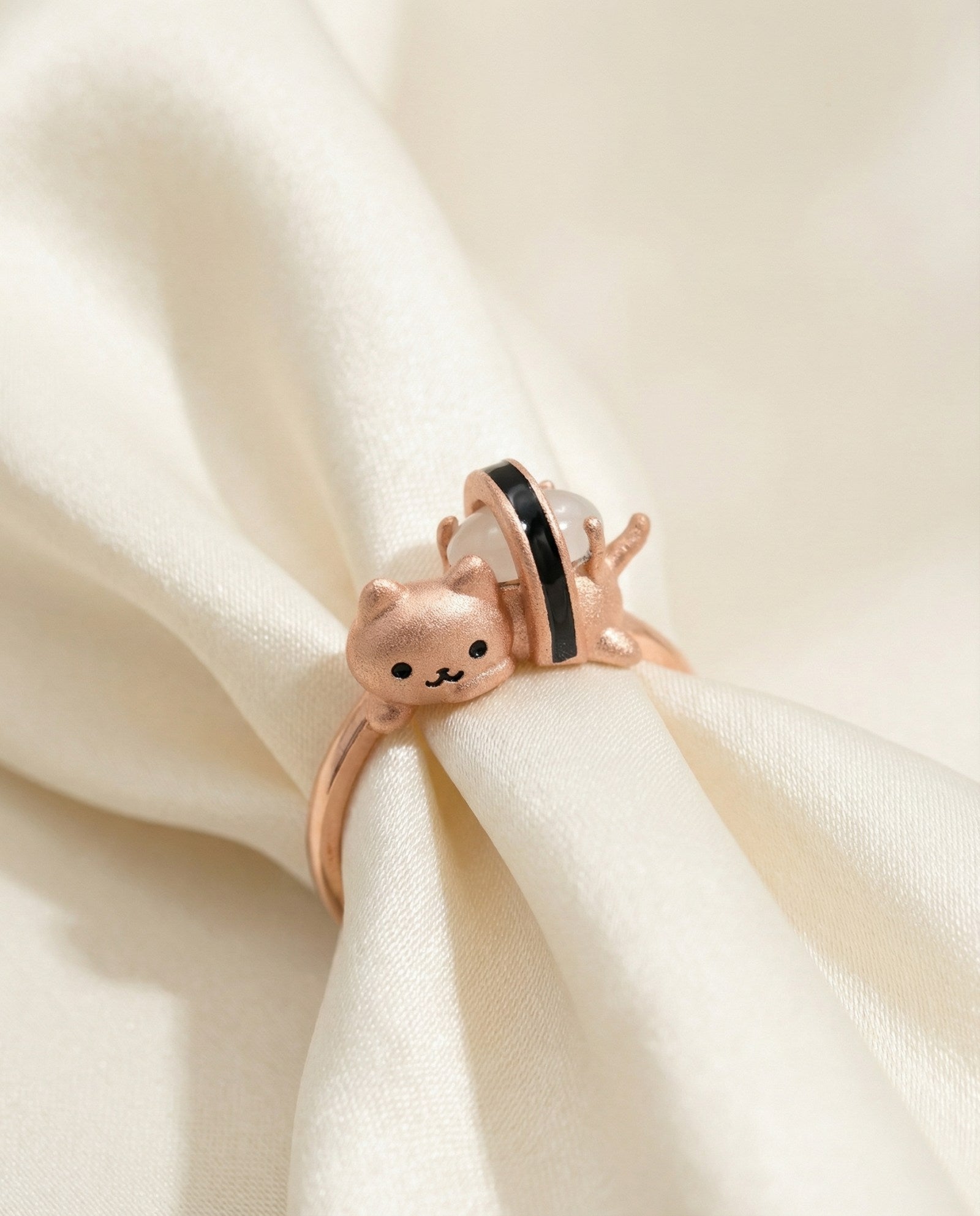 Maki Meow Sushi Ring | White Jade in rose gold, laid flat on a tabletop