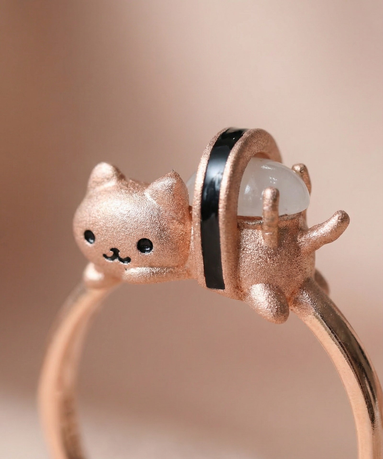 Maki Meow Sushi Ring | White Jade in rose gold, laid flat on a tabletop