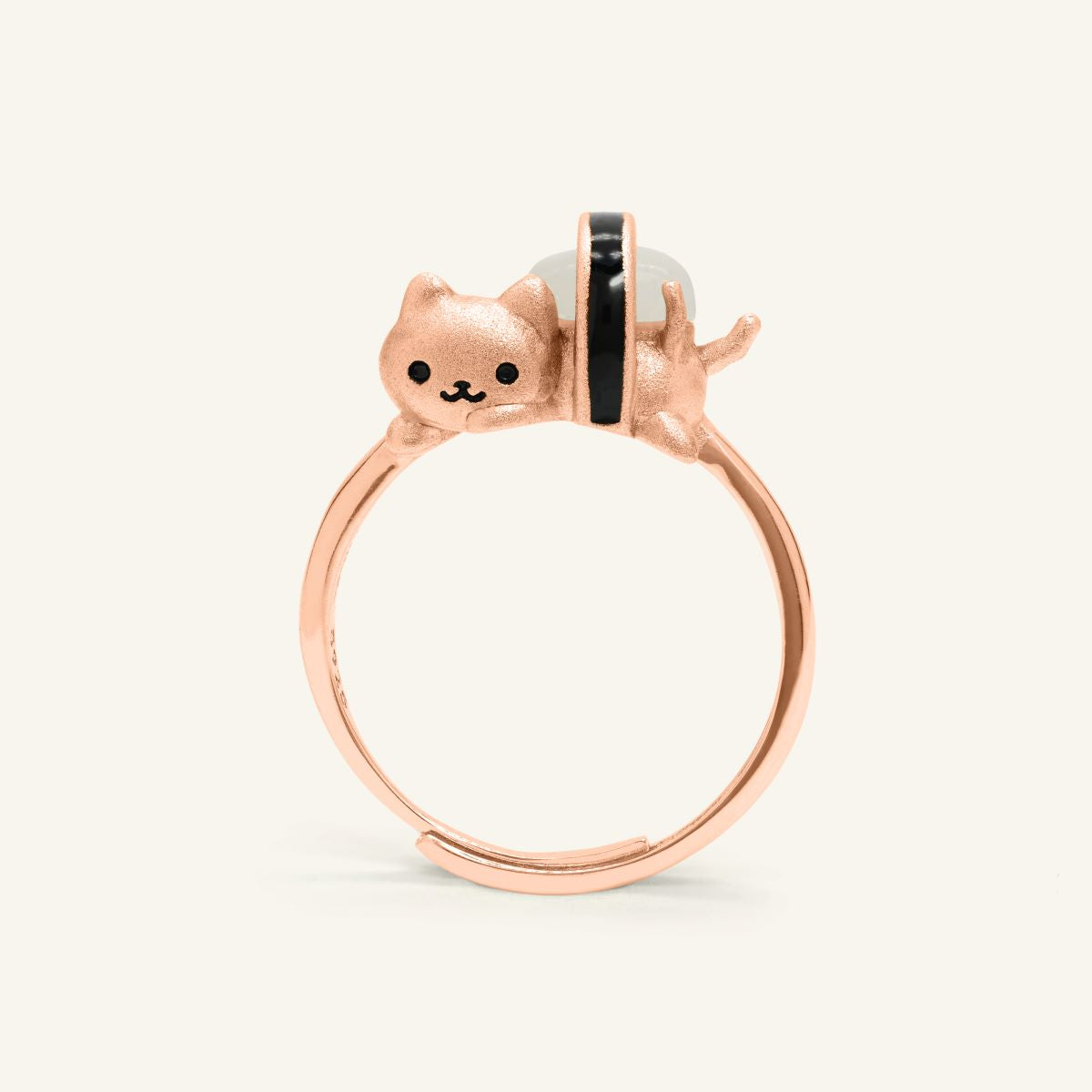 Maki Meow Sushi Ring | White Jade in rose gold, resting on a warm linen background