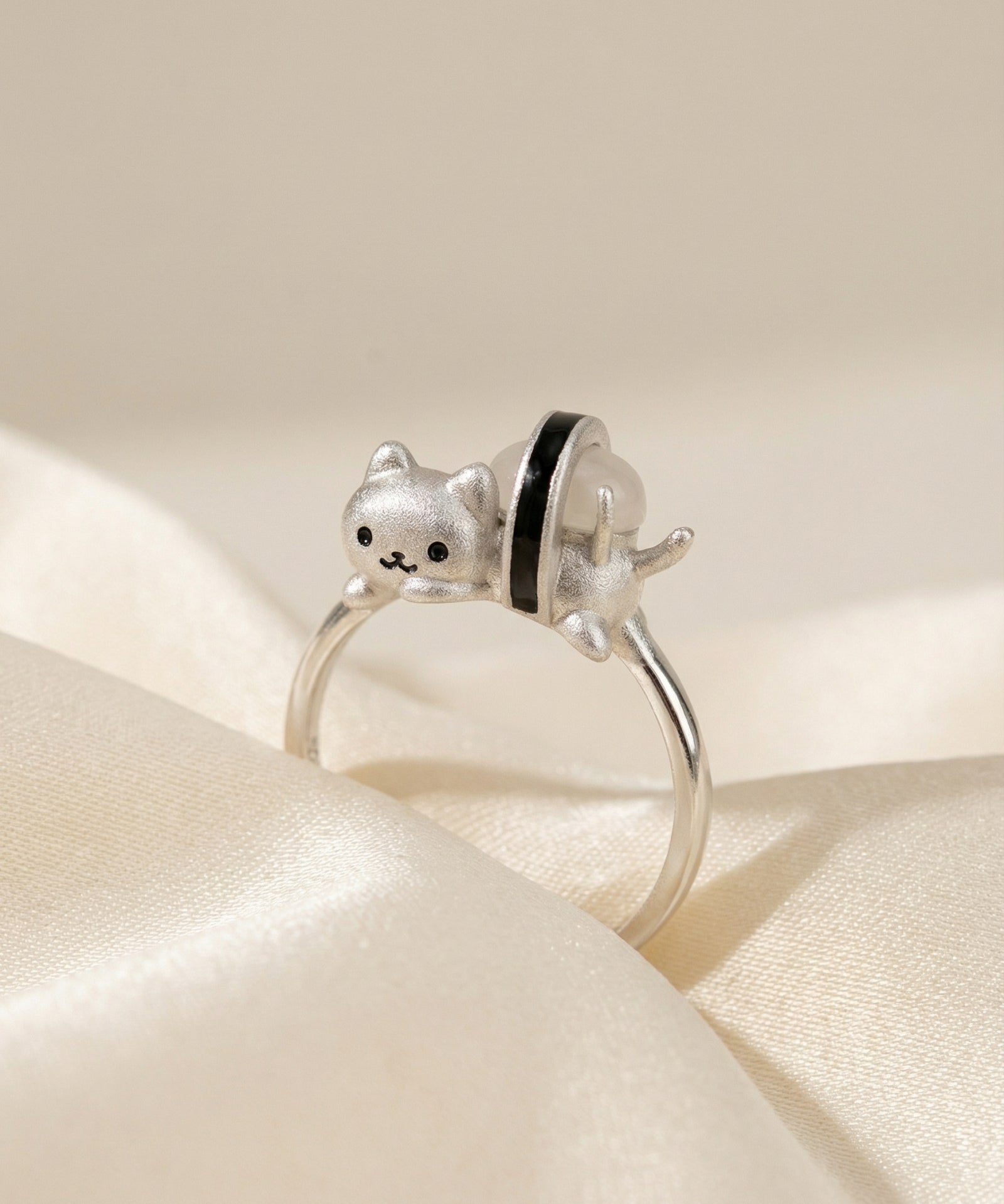 Maki Meow Sushi Ring | White Jade in silver, laid flat on a tabletop