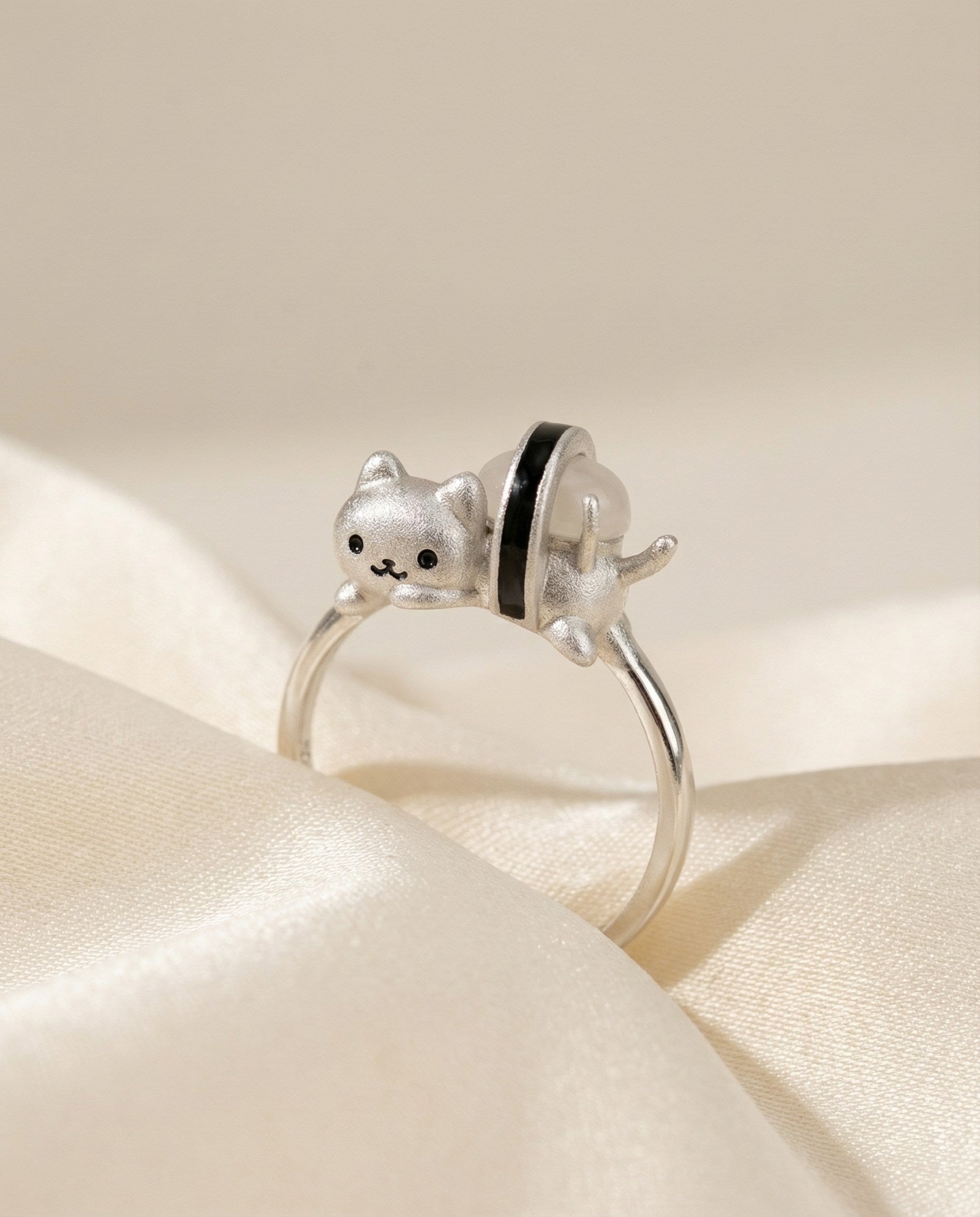 Maki Meow Sushi Ring | White Jade in silver, laid flat on a tabletop