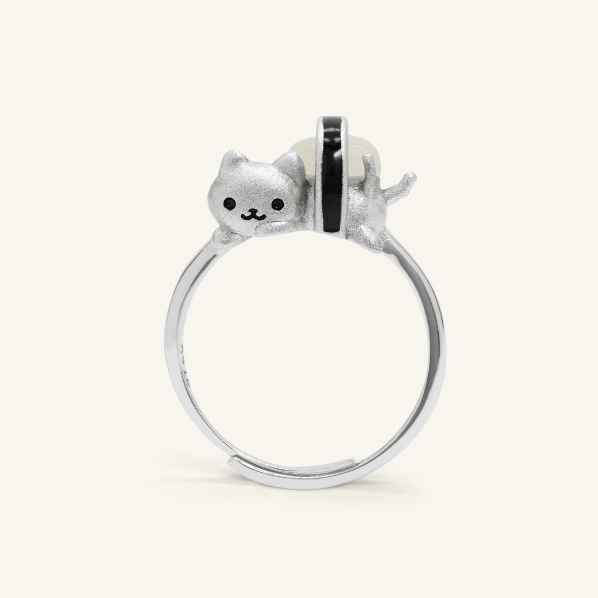 Maki Meow Sushi Ring | White Jade in silver, resting on a warm linen background