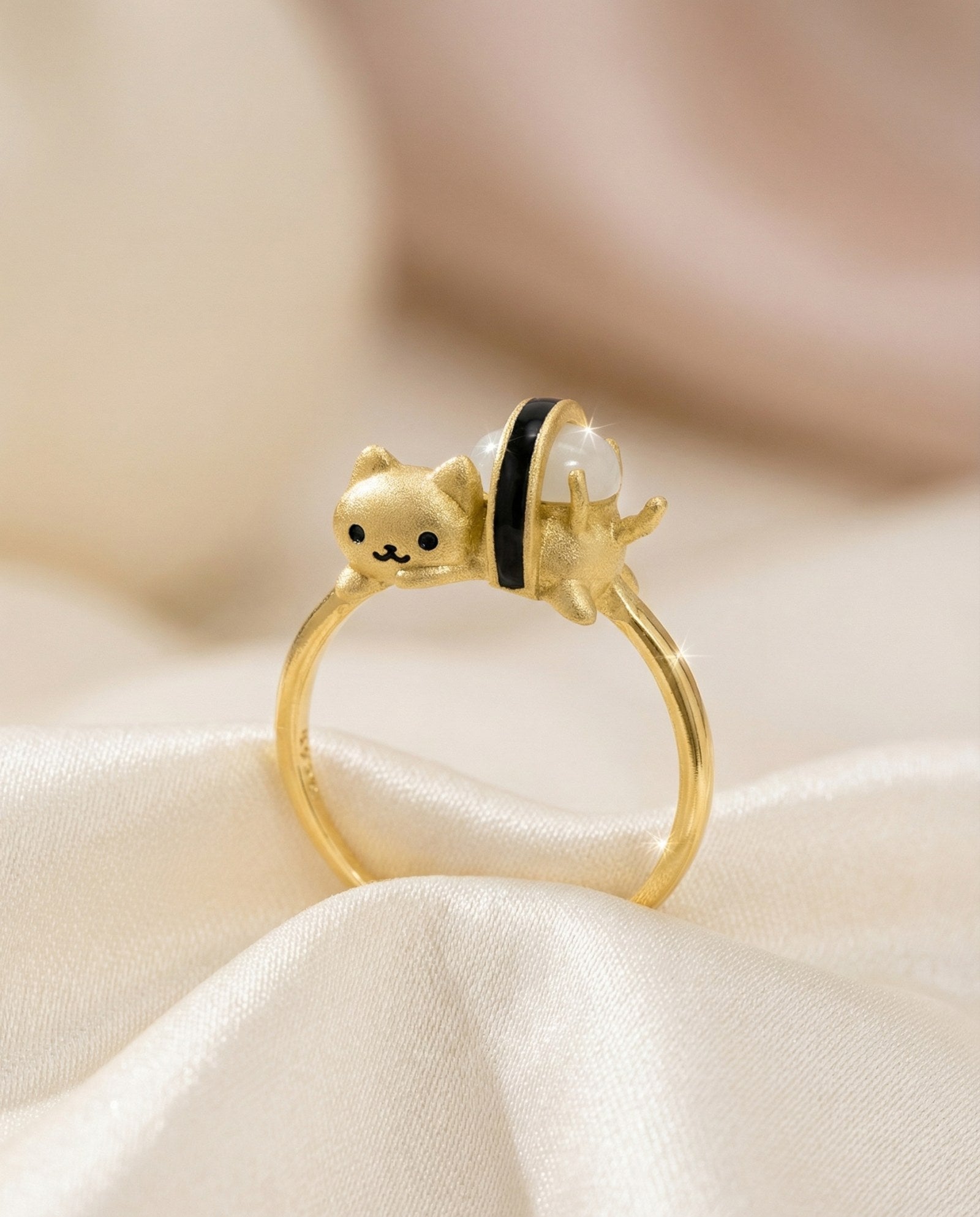 Maki Meow Sushi Ring | White Jade in yellow gold, laid flat on a tabletop
