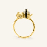 Maki Meow Sushi Ring | White Jade in yellow gold, resting on a warm linen background