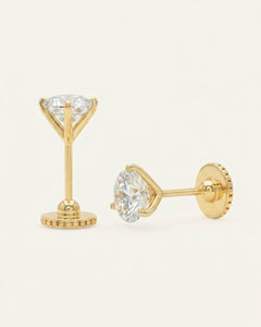 Close-up of the Martini Screwback Studs | Elate in yellow gold, resting on a warm linen background
