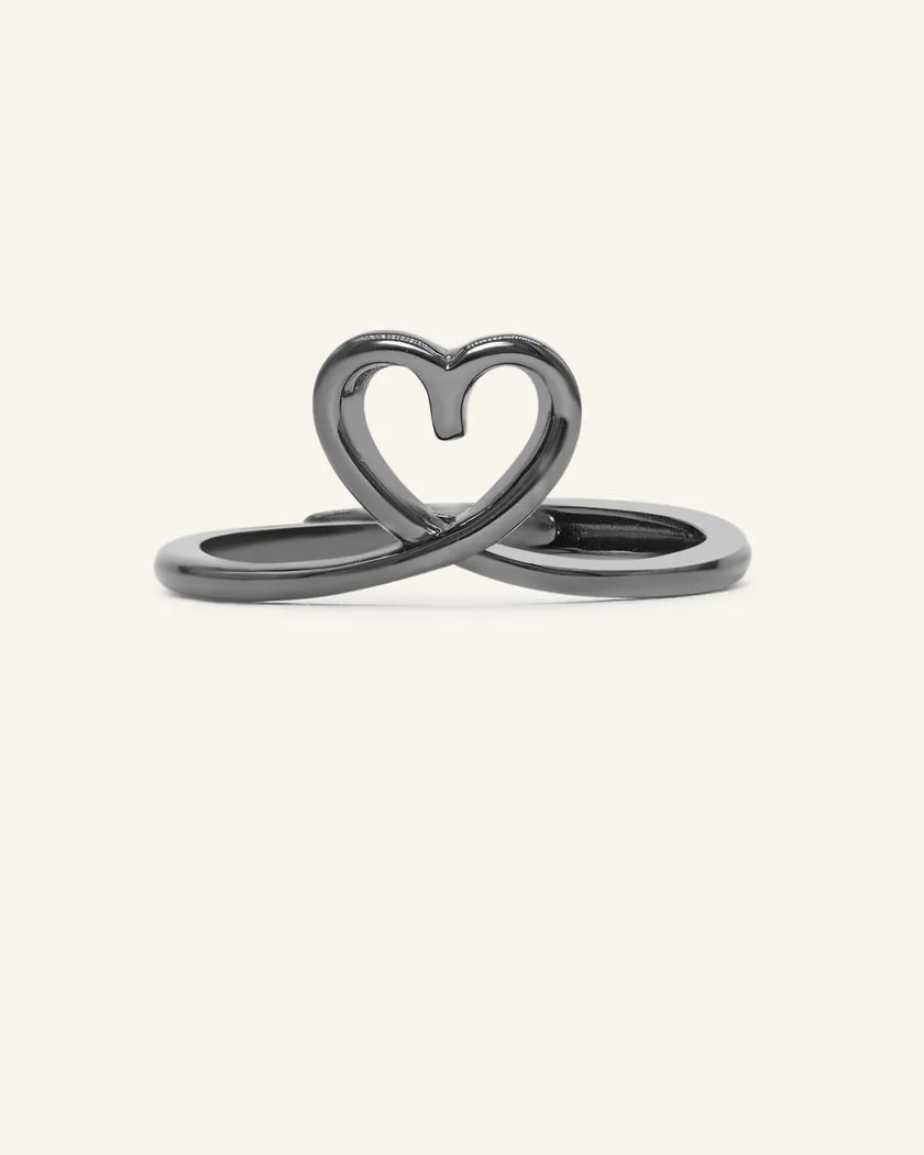 A delicate black gold midi heart ring featuring a small, open heart design formed by the intertwining of the band, sitting elegantly on the finger.