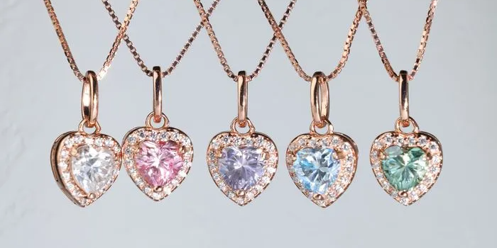 A style shot of the moissanite heart halo necklace by elate collection.