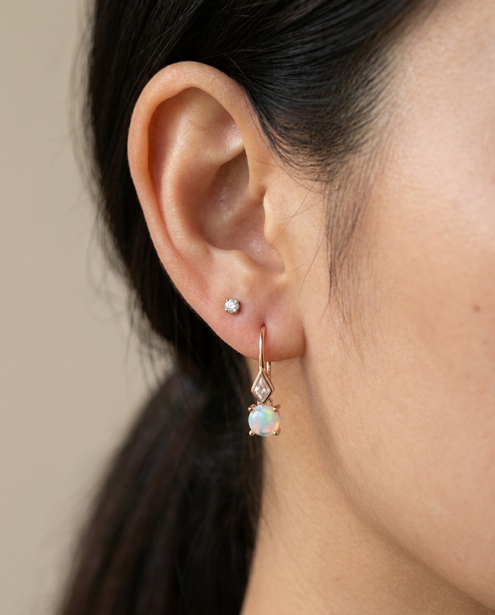 Atlas Opal Ear Drops in rose gold, worn on a model, alternate angle