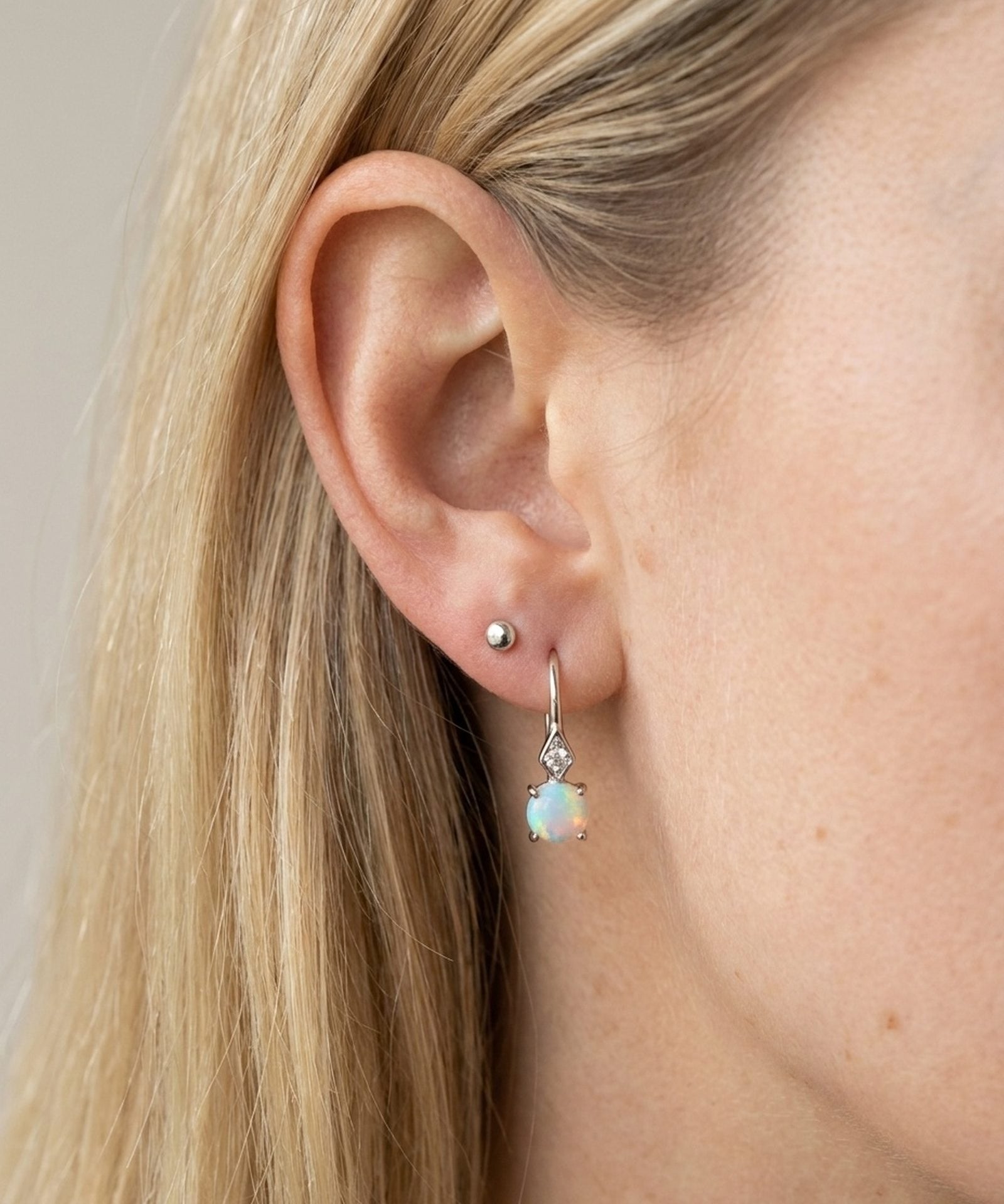 Atlas Opal Ear Drops in silver, worn on a model