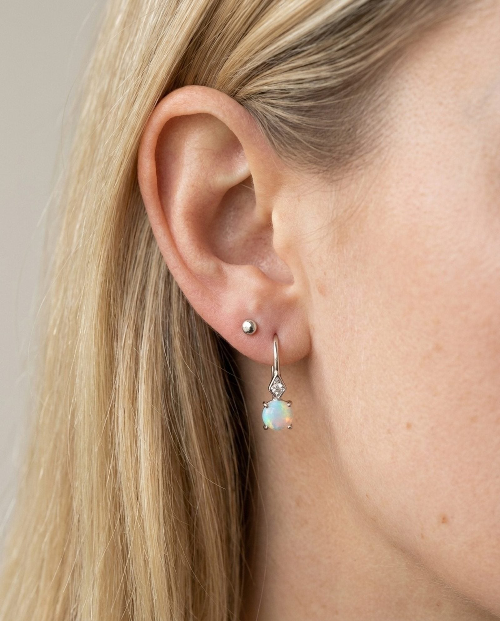 Atlas Opal Ear Drops in silver, worn on a model