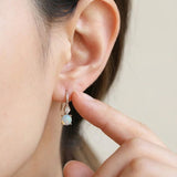 Atlas Opal Ear Drops in silver, worn on a model, alternate angle