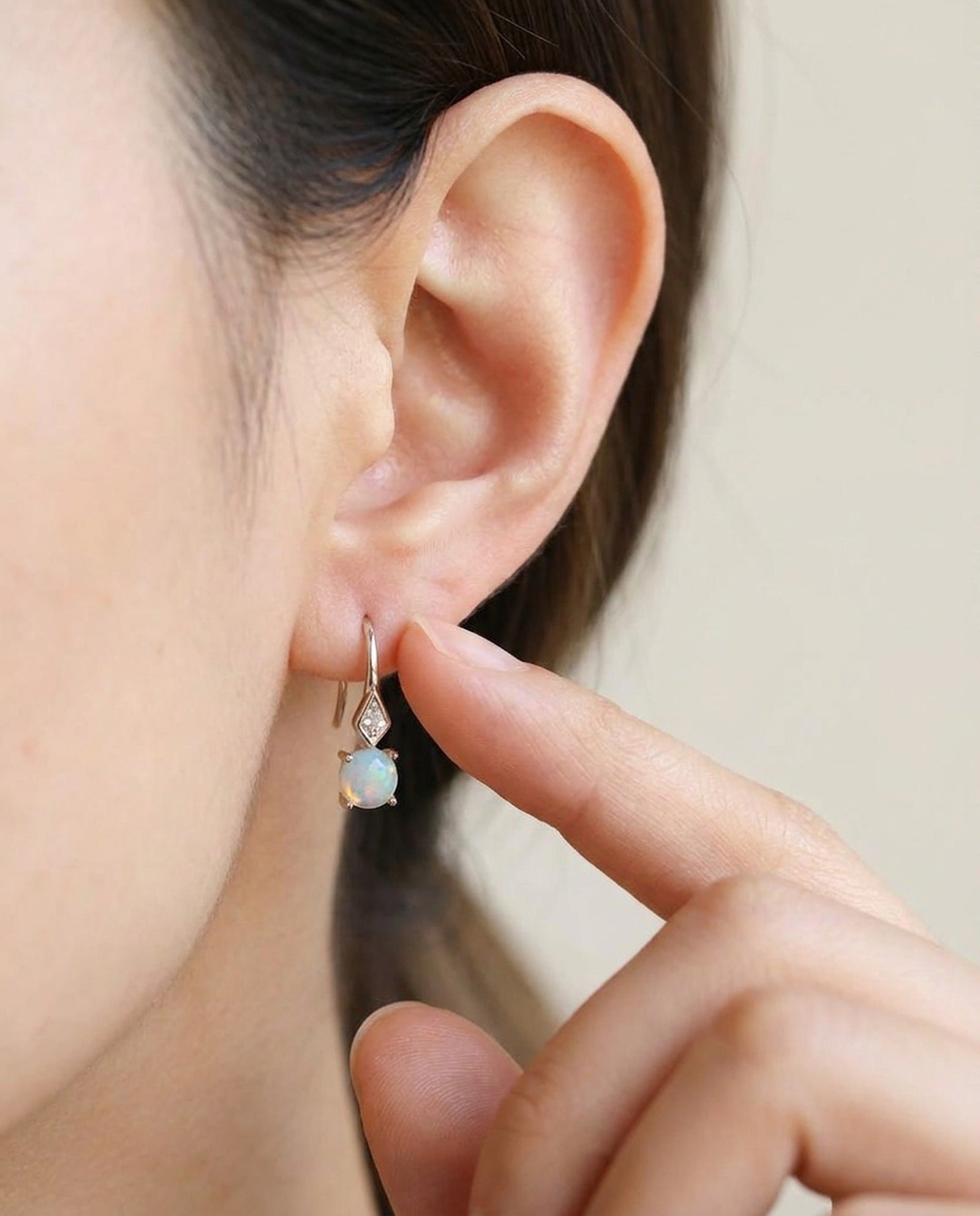 Atlas Opal Ear Drops in silver, worn on a model, alternate angle
