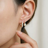 Lumi Opal Hoops in rose gold, worn on a model, alternate angle