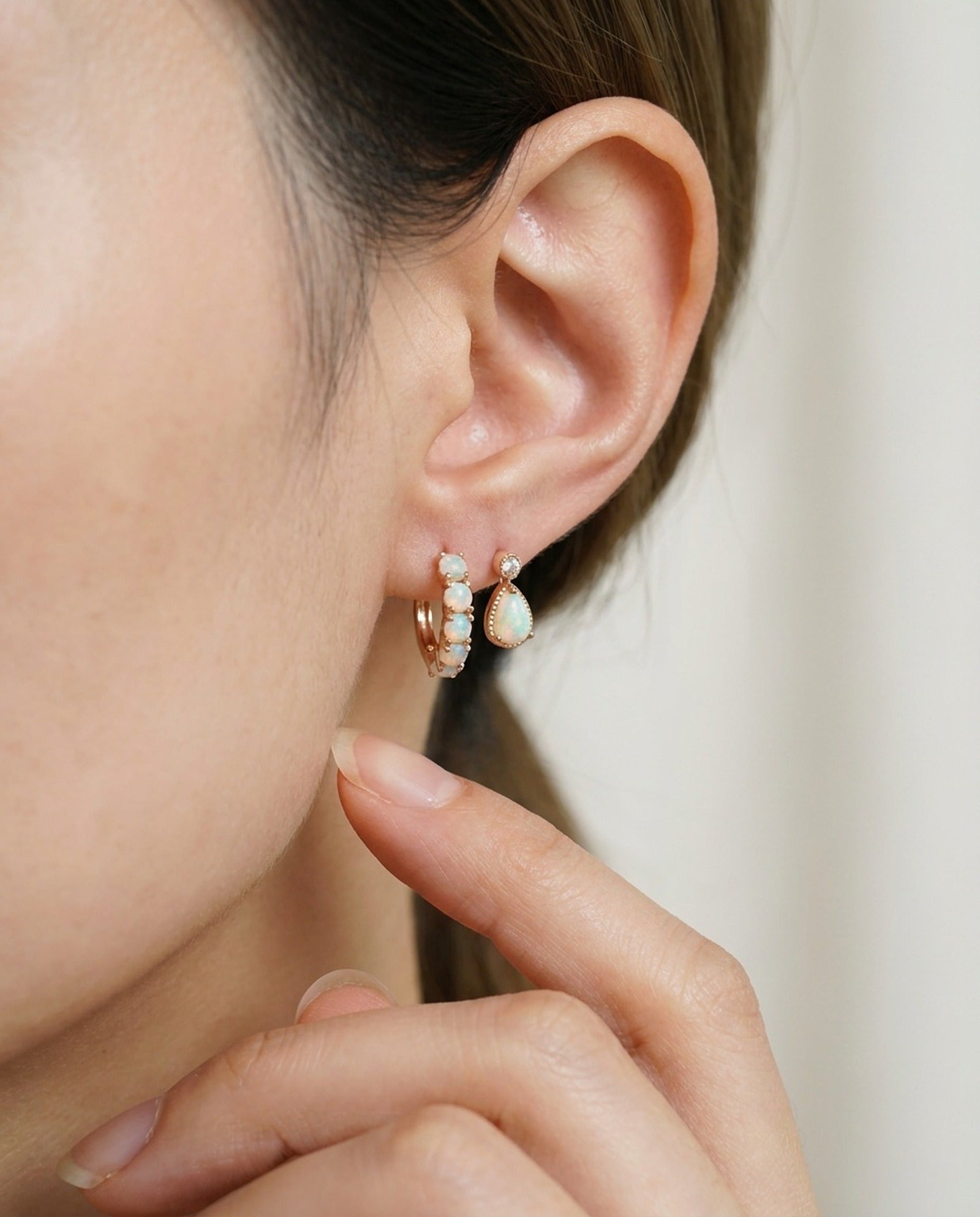Lumi Opal Hoops in rose gold, worn on a model, alternate angle