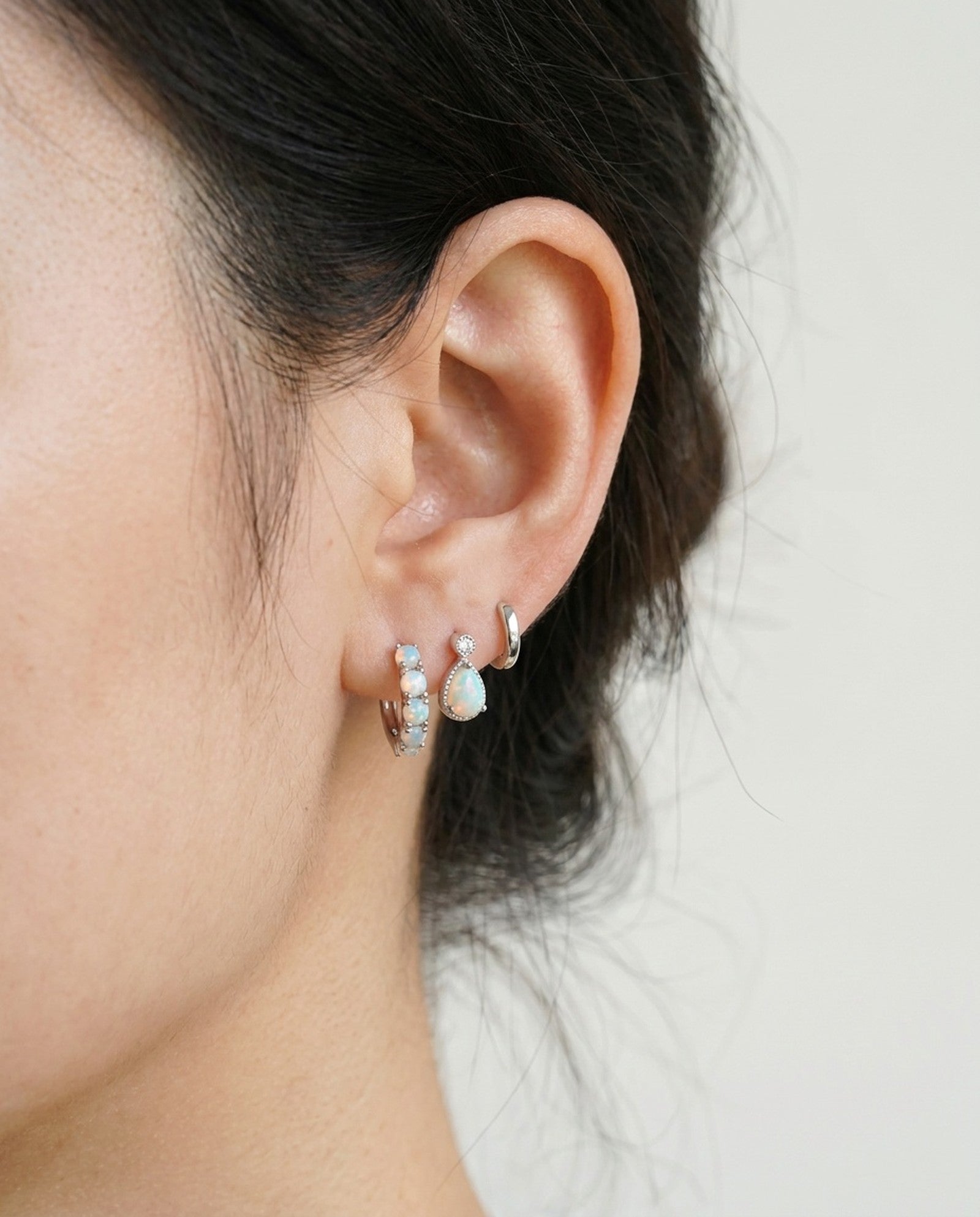 Lumi Opal Hoops in silver, worn on a model, alternate angle