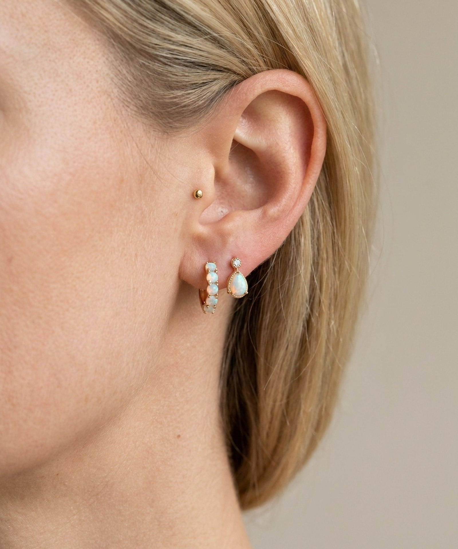 Lumi Opal Hoops in yellow gold, worn on a model