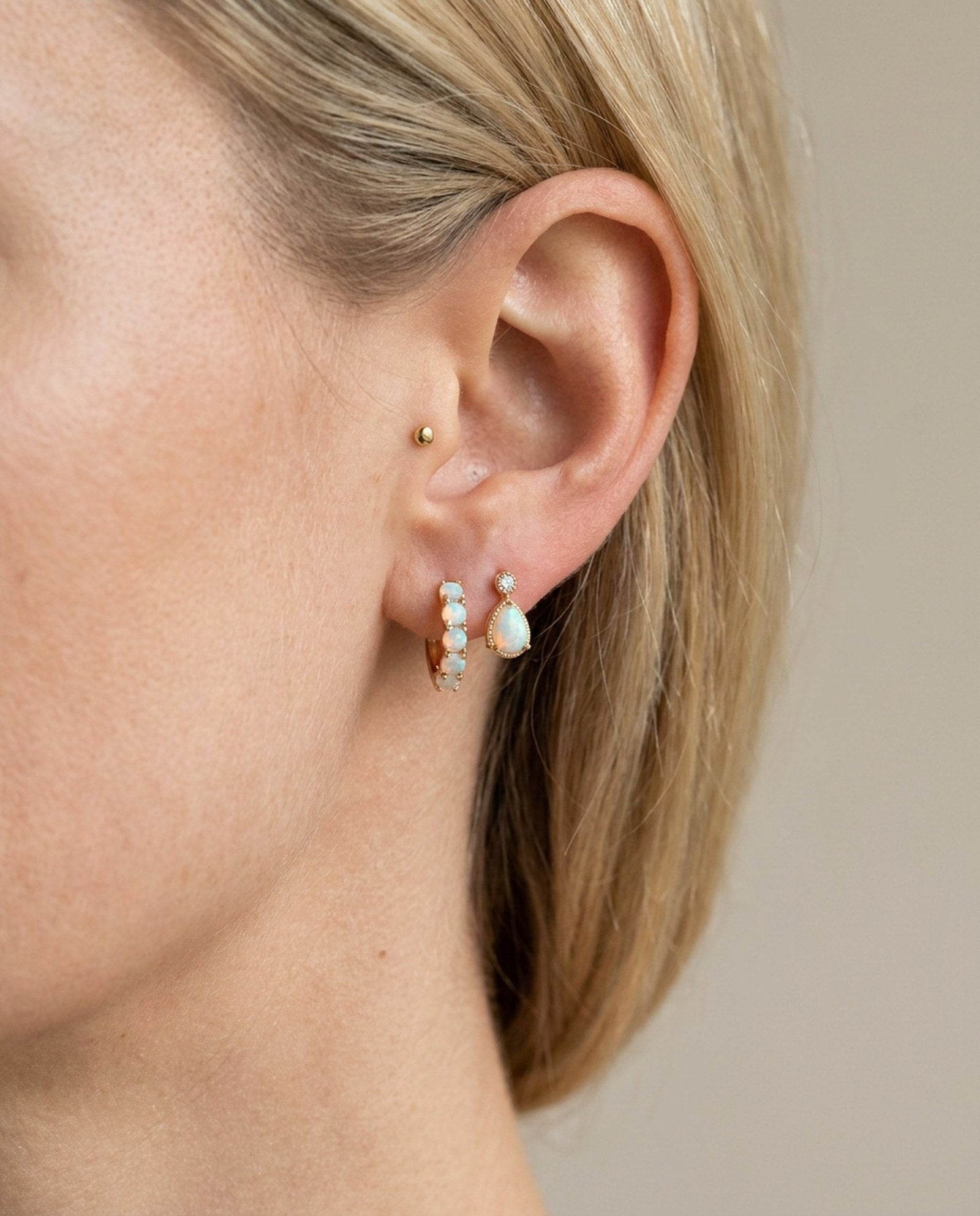 Lumi Opal Hoops in yellow gold, worn on a model
