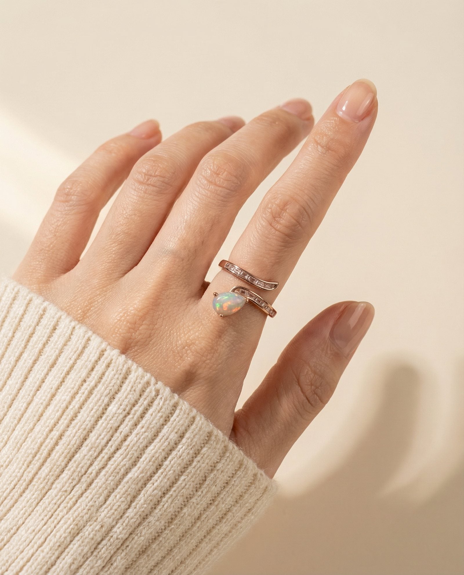 Opal Serpentine Ring with pear-cut natural opal and baguette stones in 18k Rose Gold over 925 Silver worn on hand