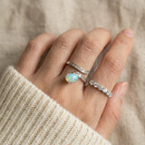Pear cut natural opal ring paired with eternity moissanite band