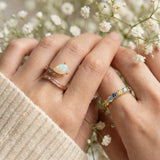 Teardrop Ethiopian opal ring and baguette stones in Rose Gold worn on model