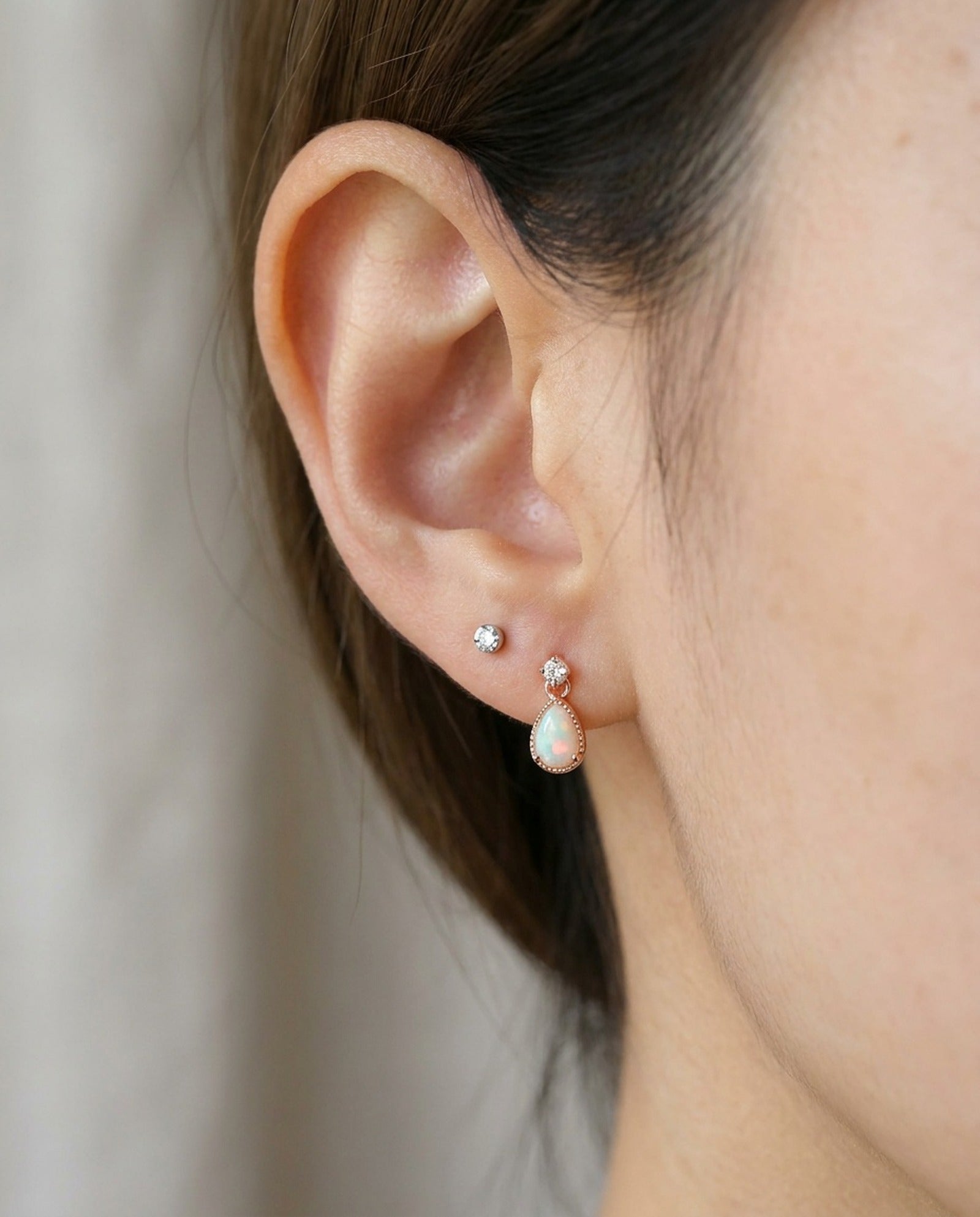 Suri Opal Teardrop Studs in rose gold, worn on a model