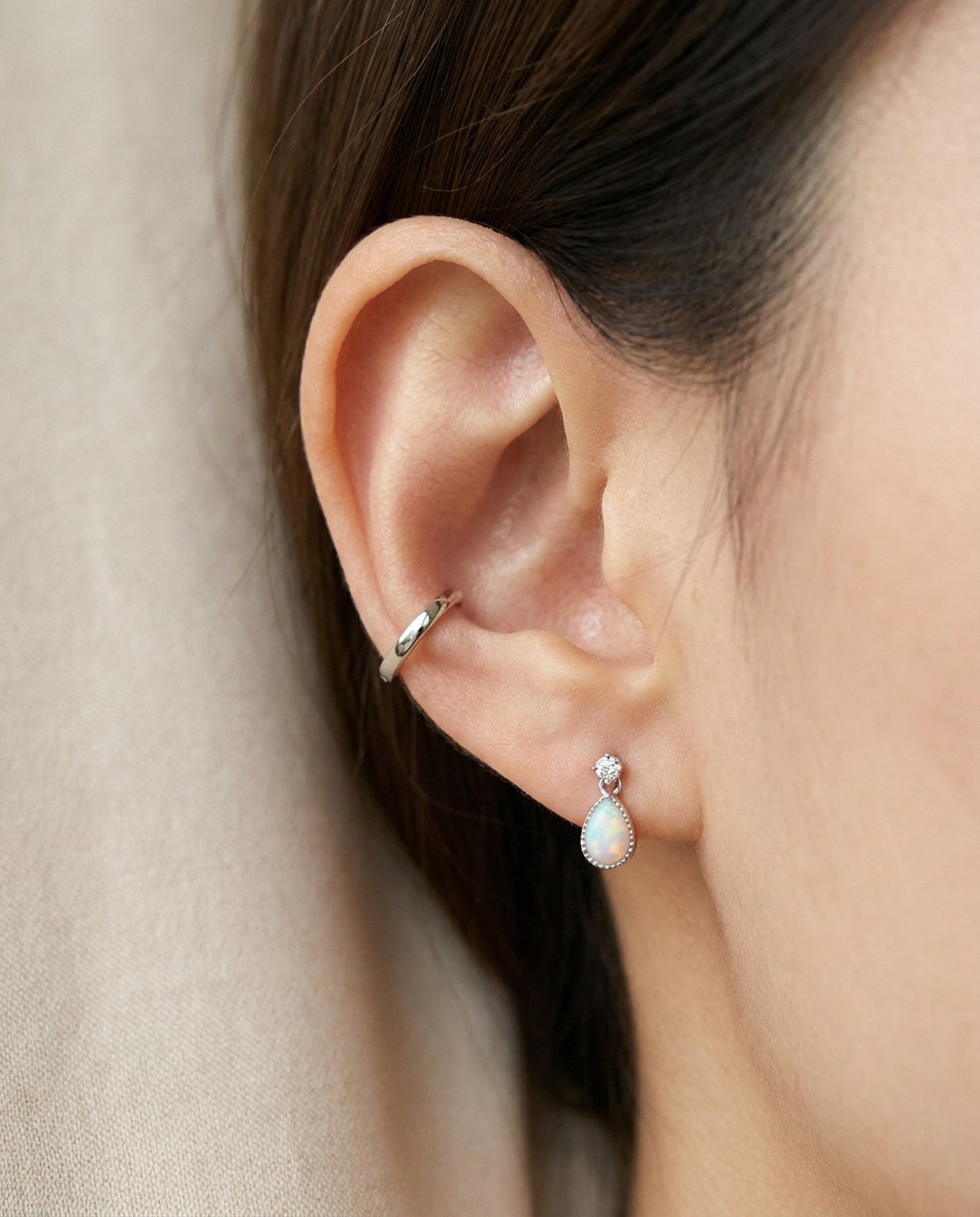 Suri Opal Teardrop Studs in silver, worn on a model