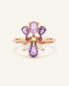 Orchid Ring | Multi-Gemstone in rose gold, resting on a warm linen background