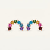 Pair of rose gold multi-gemstone rainbow arc stud earrings displaying a symmetrical vibrant crystal gradient.
