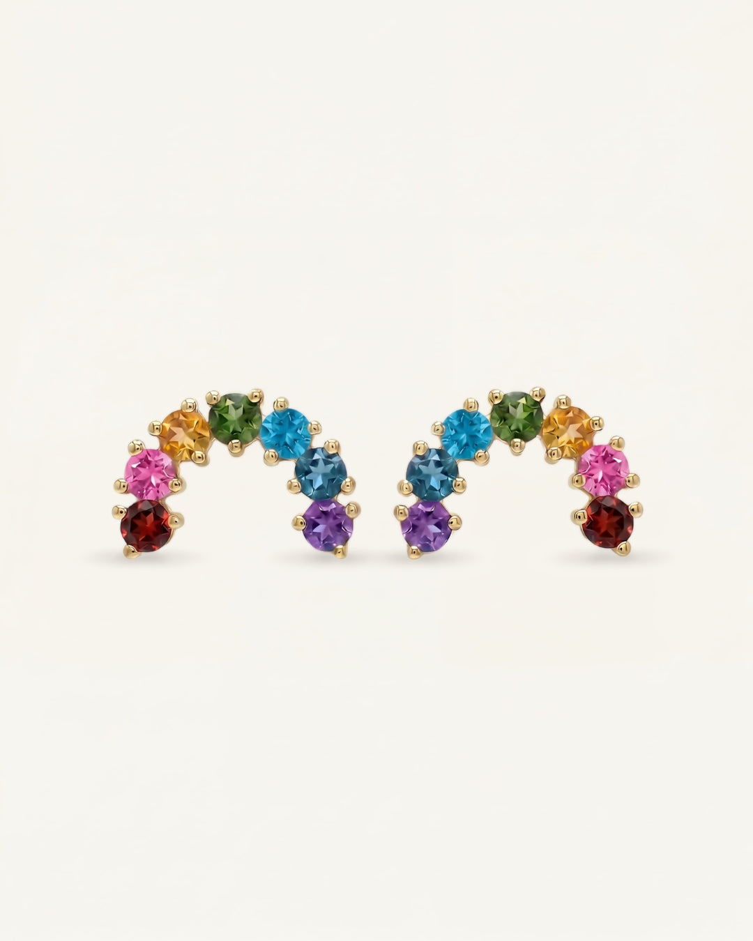 Pair of 18k gold vermeil over the rainbow arc studs featuring seven natural round-cut color gradient gemstones.