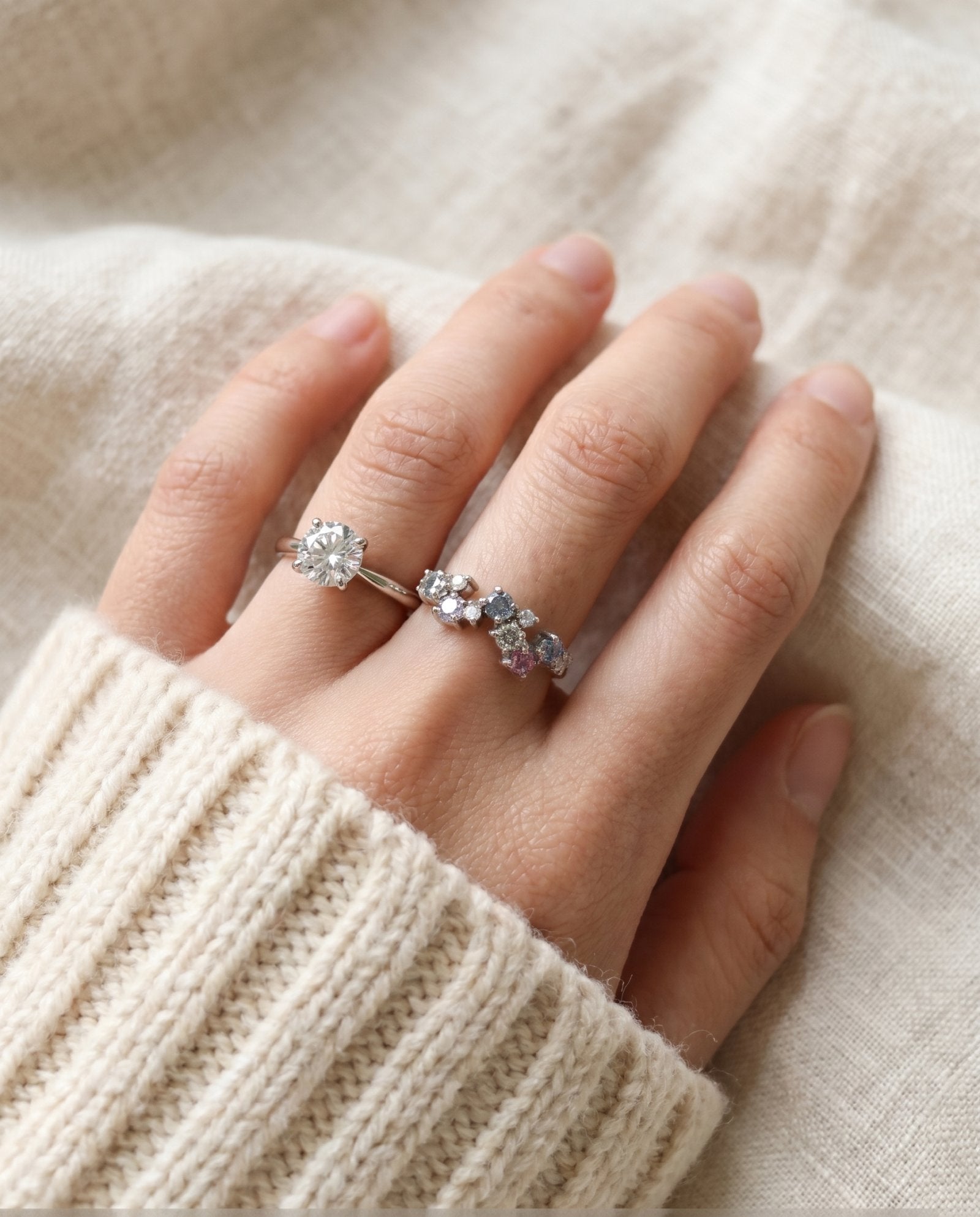 Lifestyle shot of the Painter’s Palette Ring in Silver stacked with a brilliant-cut solitaire to demonstrate a high-end, artistic ring stack.