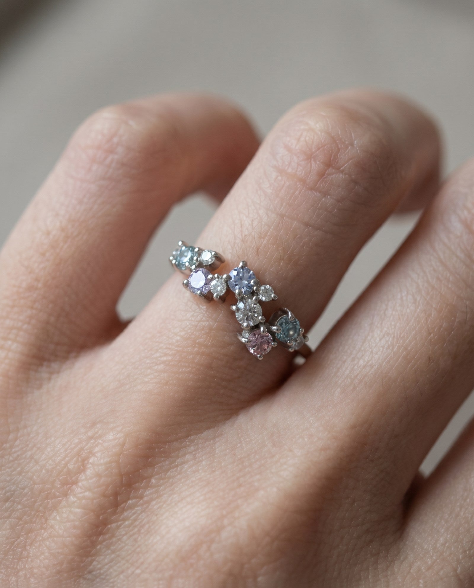 Scale view of the Painter’s Palette moissanite ring in silver worn on a finger to show the organic, hand-painted silhouette.