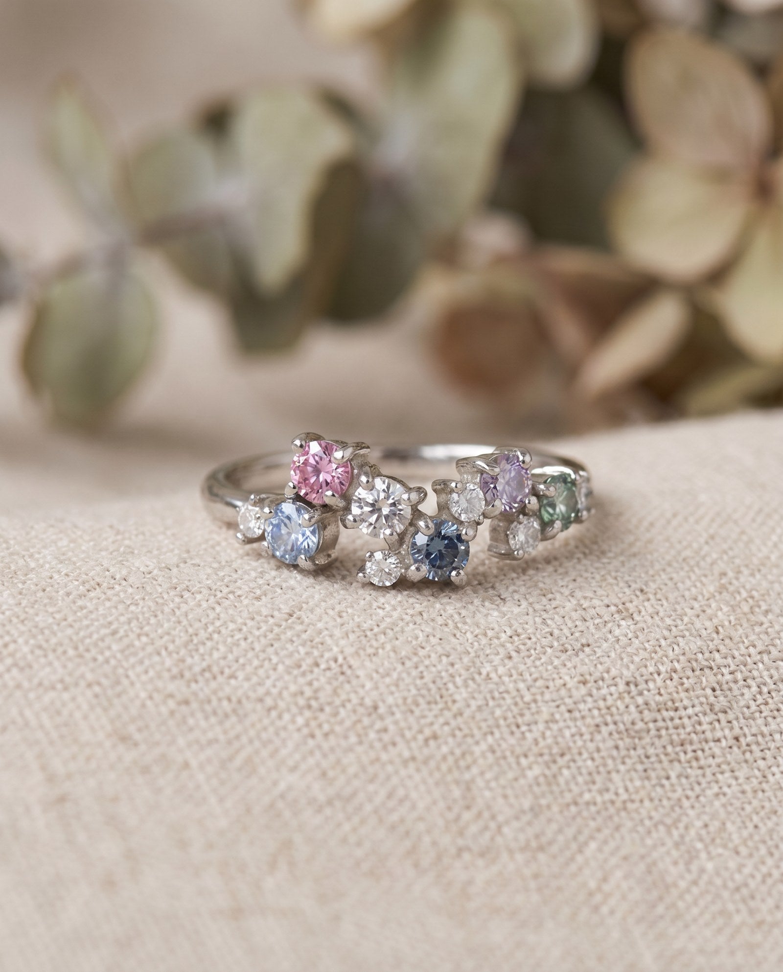 Extreme macro detail of the Painter’s Palette Ring, showing the different pastel tones and high-brilliance fire of the moissanite stones.