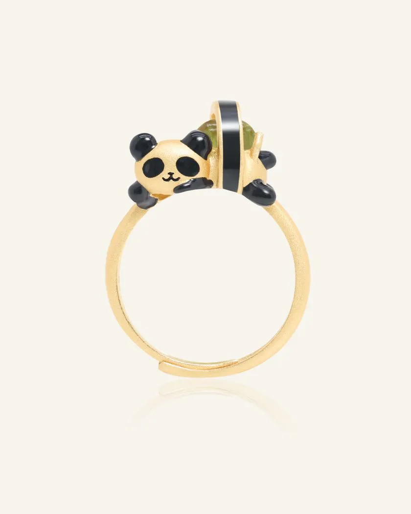 A whimsical panda sushi roll ring crafted in yellow gold, featuring an adorable panda as a sushi roll. The sushi roll is set with a vibrant peridot gemstone, adding a playful and elegant touch.